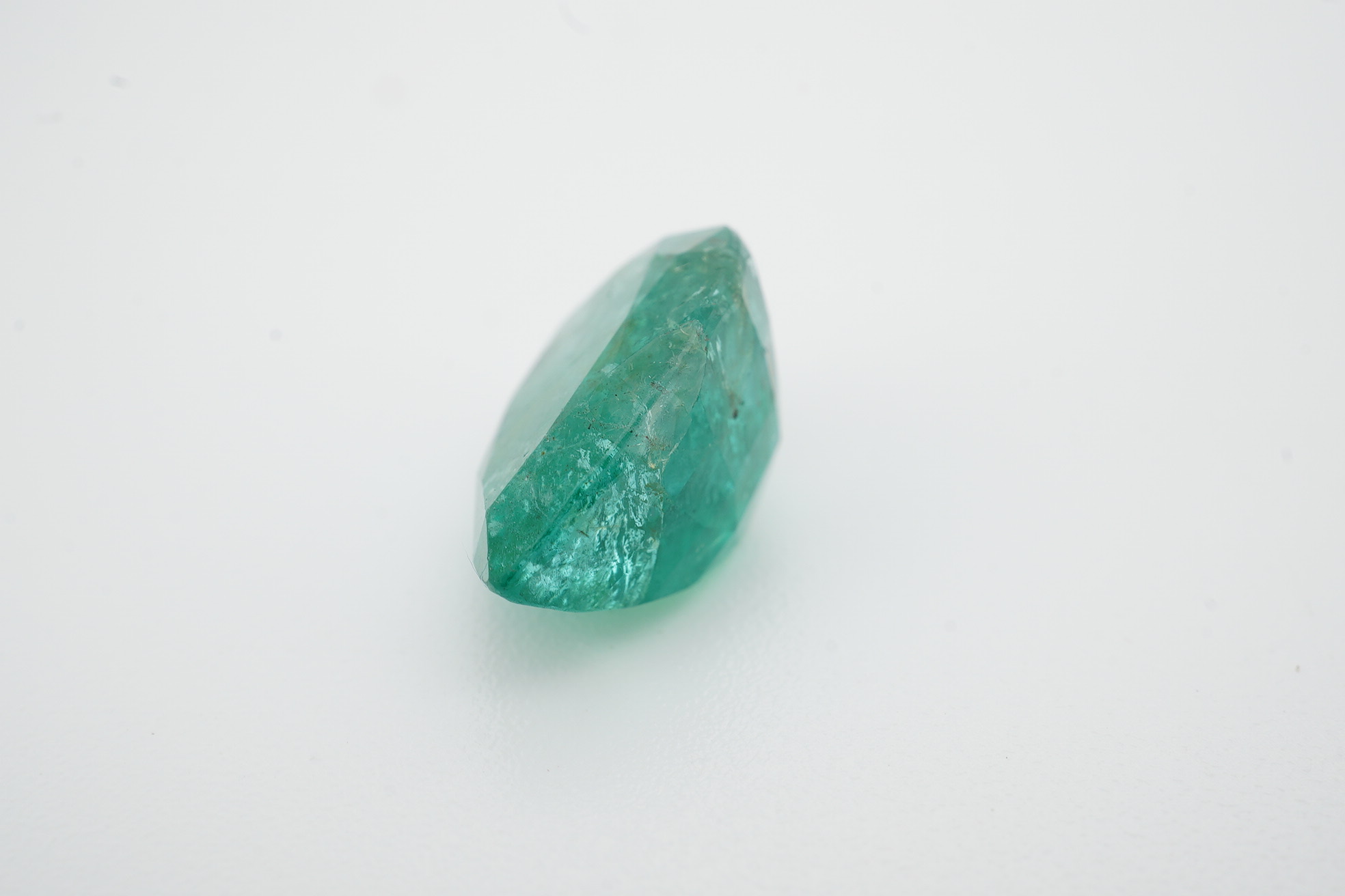 An unmounted pear cut emerald, weighing 6.32ct. Condition - poor to fair